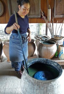 Ms. Sisane of the Lao Traditional Culture and Education Center in Vientiane stirs the fermenting indigo dye bath. 