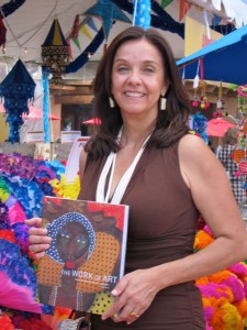 Carmella Padilla with The Work of Art (and a sea of Mexican paper flowers) at the Folk Art Market