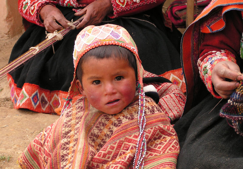 Peruvian Child wearing hand knitted hat from the village of Accha Alta.