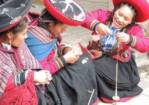 Chinchero young women chat while spinning away. 