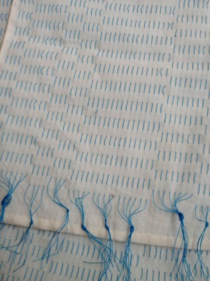 Woven shibori scarf blank before scouring or dyeing. 