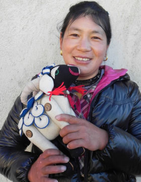 Yondron holds one of the Tibetan sheep she has made. 
