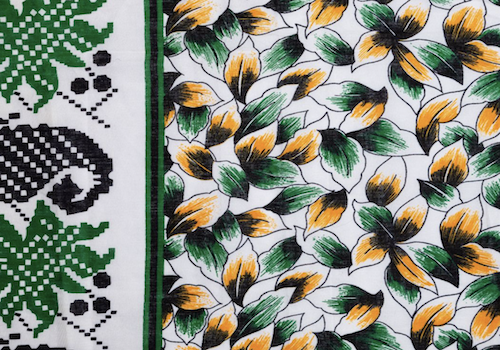 Kanga from Kenya typically have three design elements: central motif, border, and a proverb or saying usually in Swahili.